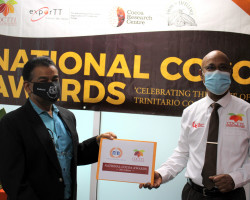Mr. Kelvin Mahabir CEO (left) of the National Flour Mills Ltd, with the Chairman of the National Organising Committee, Mr. Leon Granger, (CDCTTL CEO)